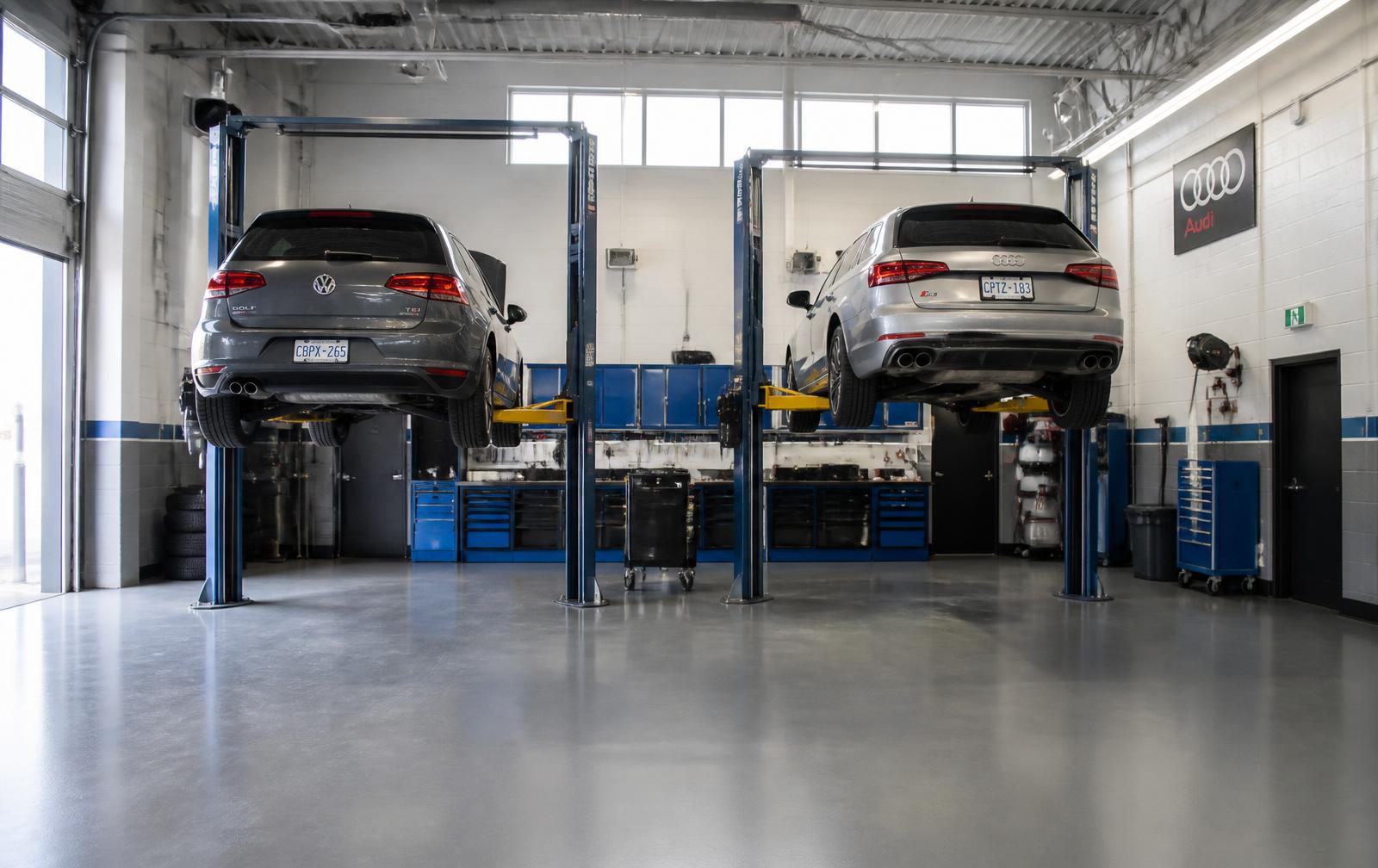 Clean service bay at Saskatoon Import Auto Service with a European car on the hoist